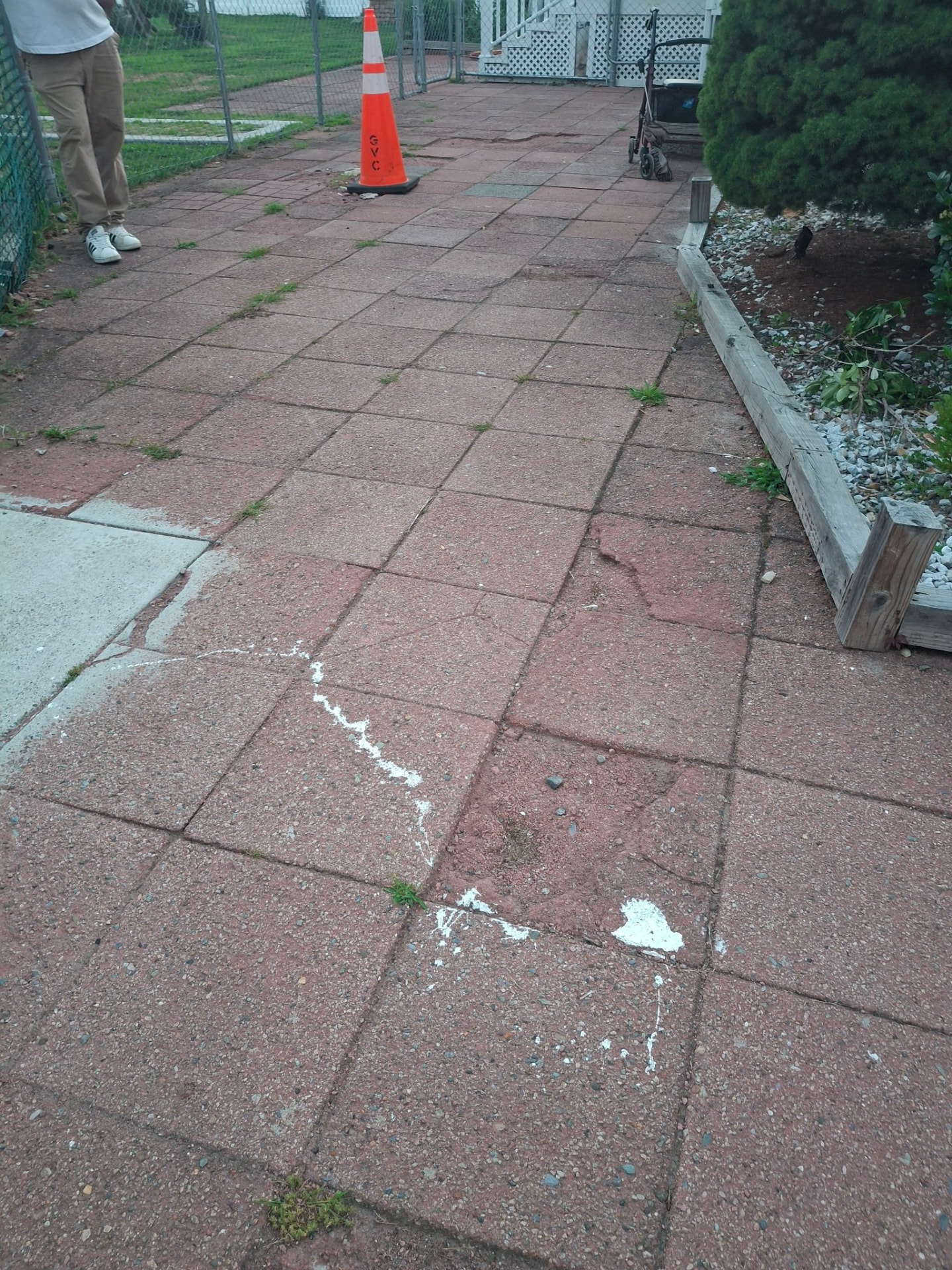 Worn red paver walkway before replacement